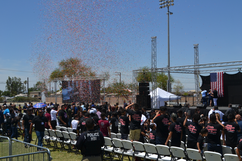 An ICE agent looks on as confetti flies and Andy Ruiz Jr. is handed the key to the city.